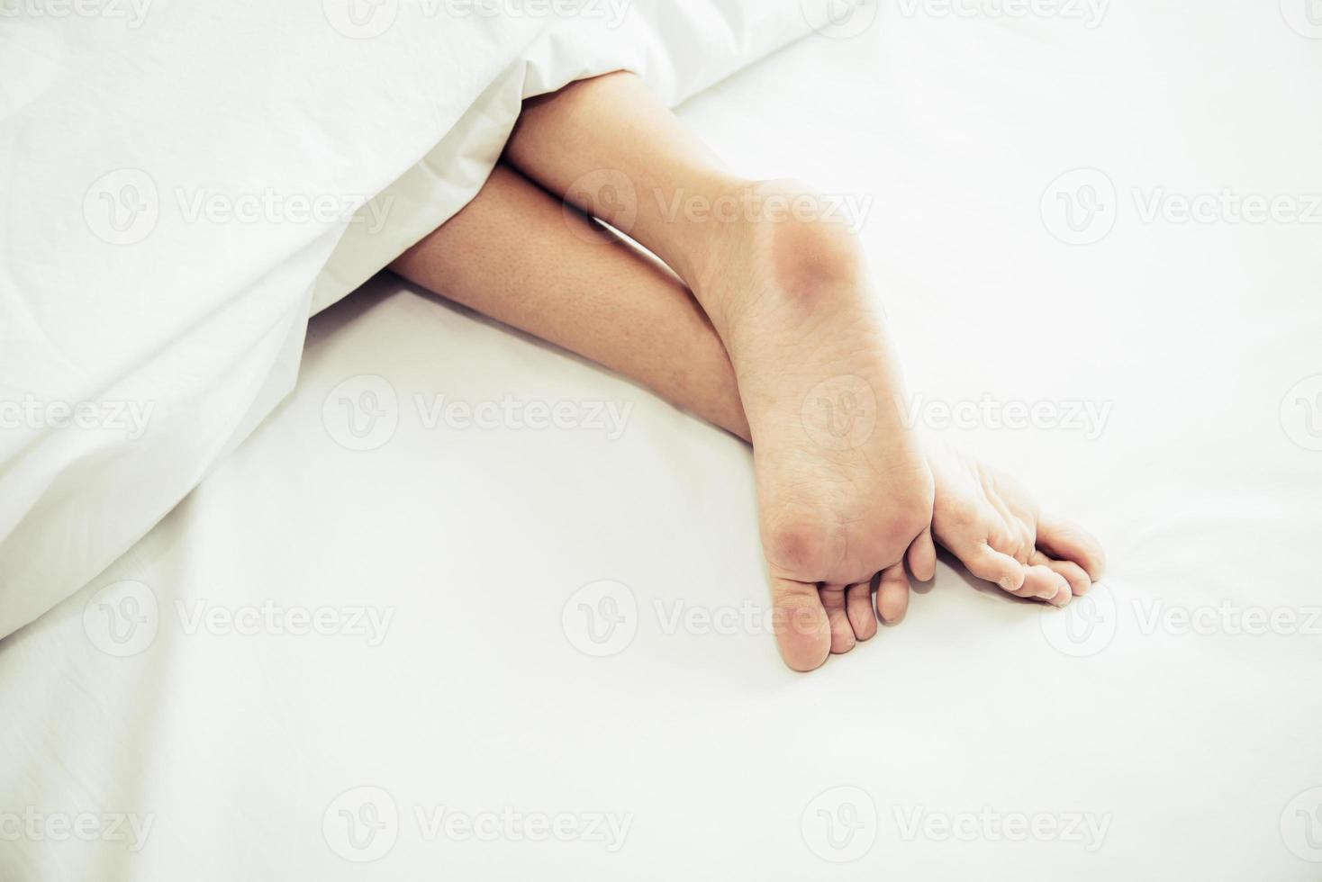 Barefoot of human on bed in morning. single and working people photo