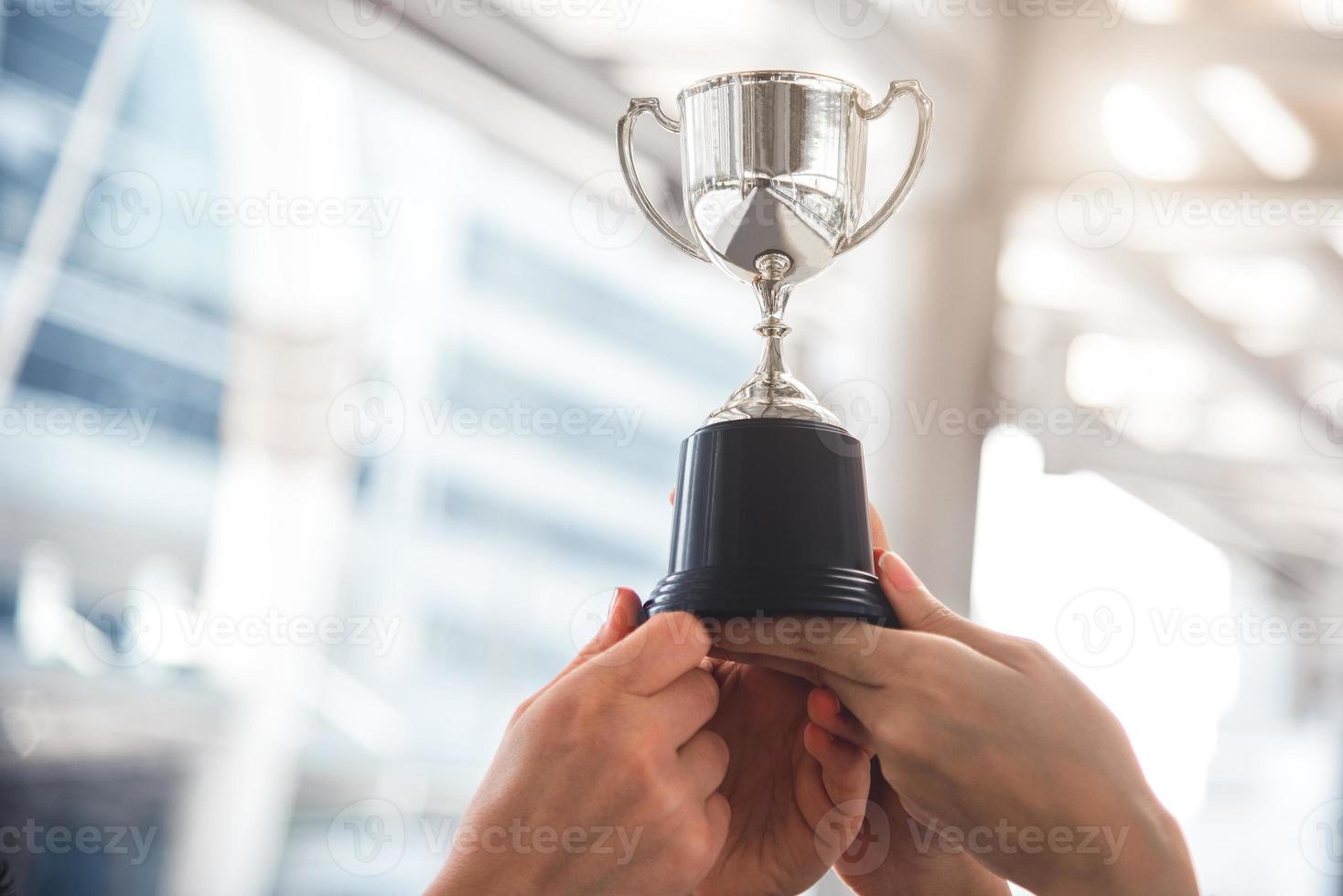 Champion silver trophy for runner up winner with sport player hands photo