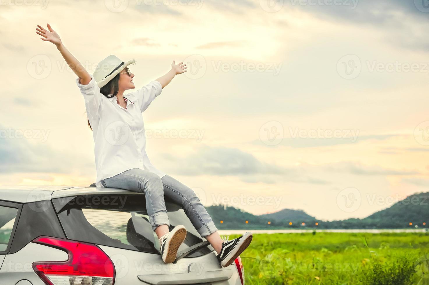 Happy Asian woman spread arms widely and breathed fresh air photo