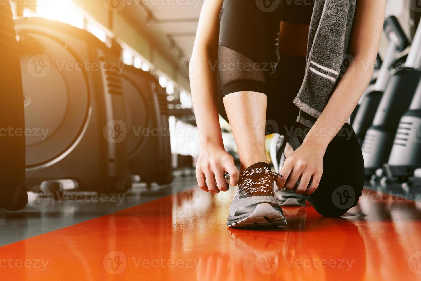 Sport woman tying sneakers rope. Sport center and Fitness gym concept photo