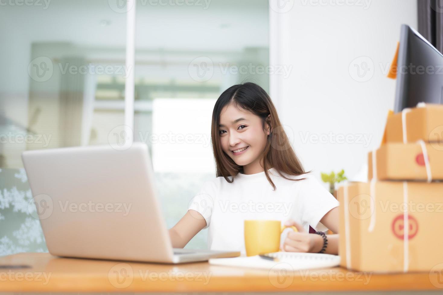 Asian woman with parcel boxes in delivery service and online shopping photo