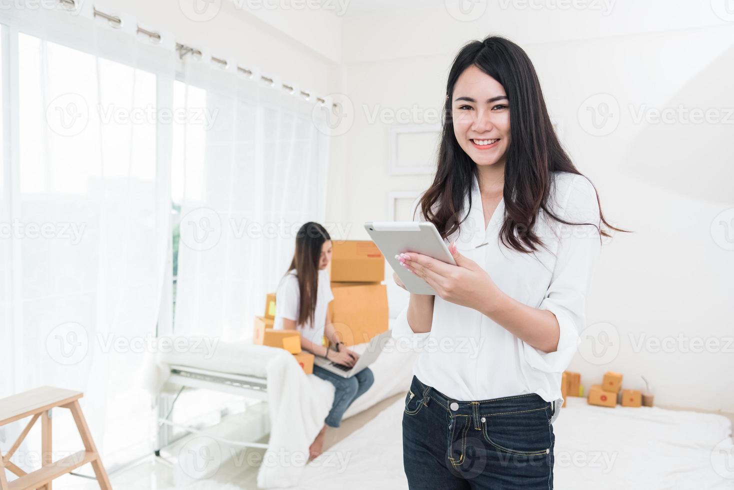 Beauty Asian woman using tablet for checking order from customers photo