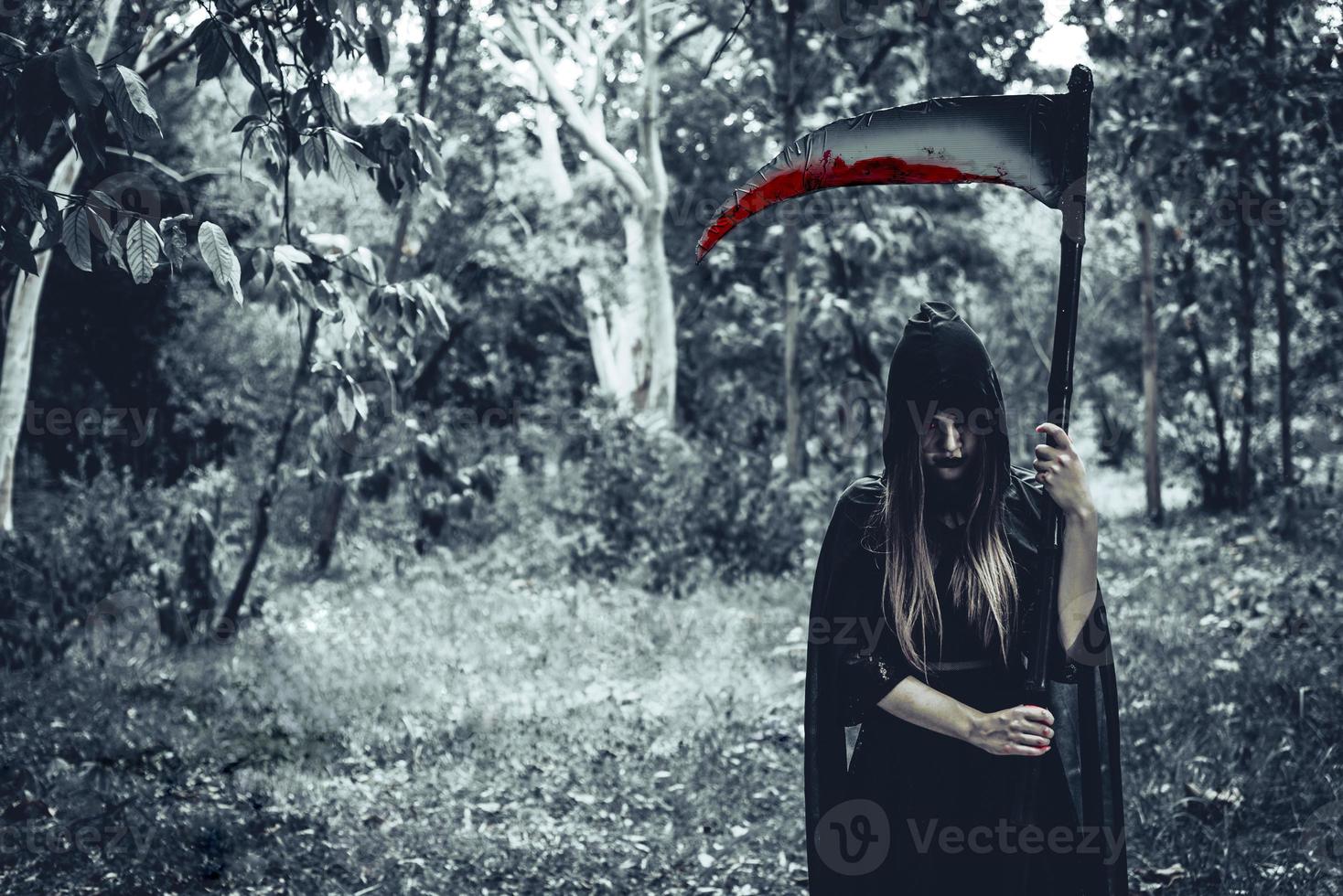 Female demon witch with bloody reaper photo