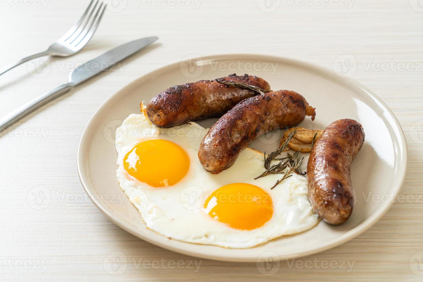 double fried egg with pork sausage photo