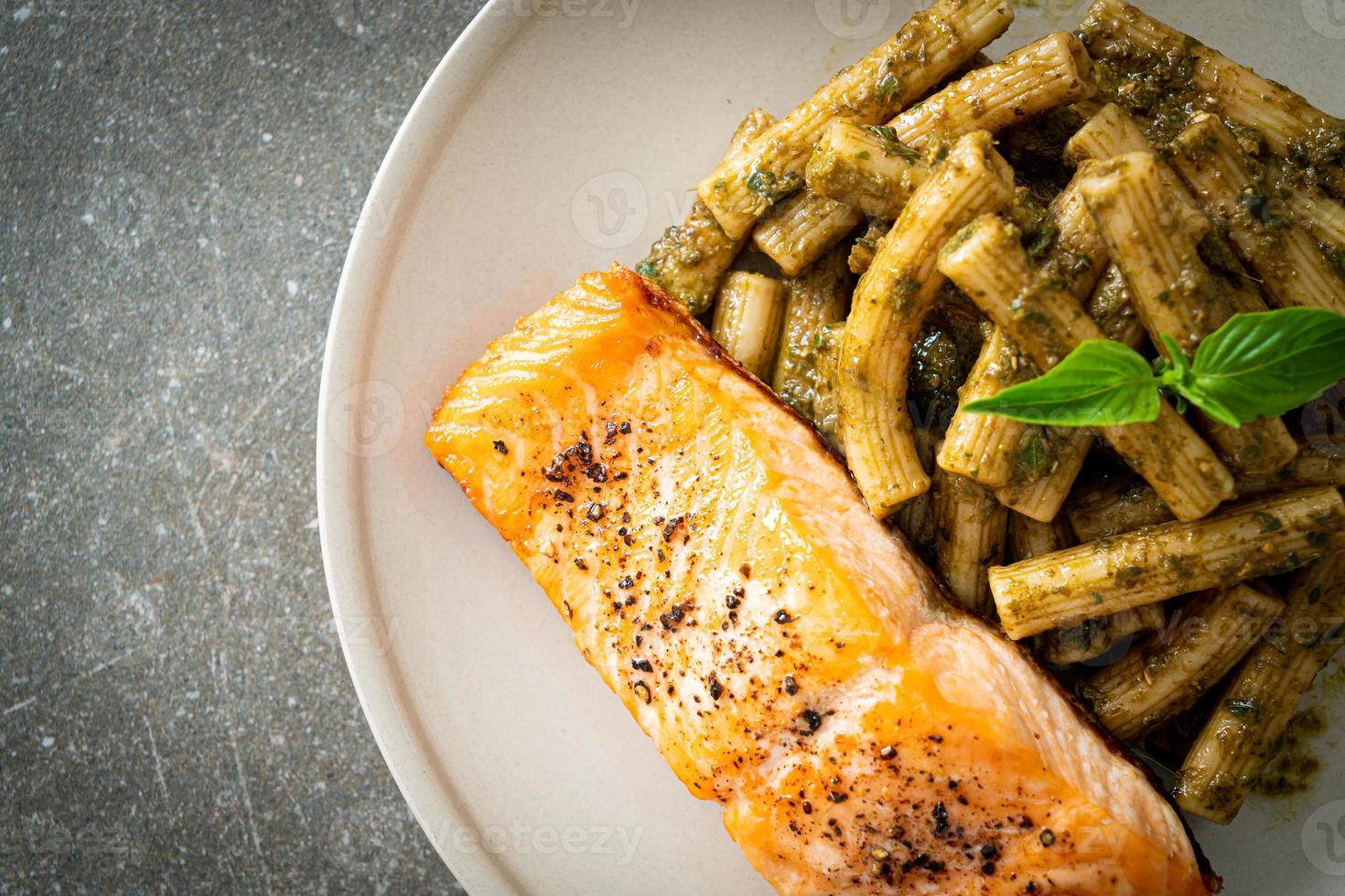 pesto quadrotto penne pasta with grilled salmon photo