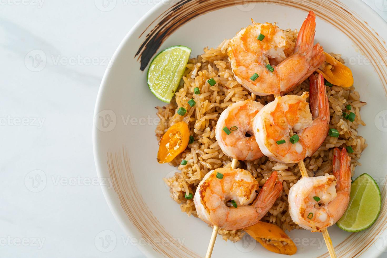 fried rice with shrimps skewers photo