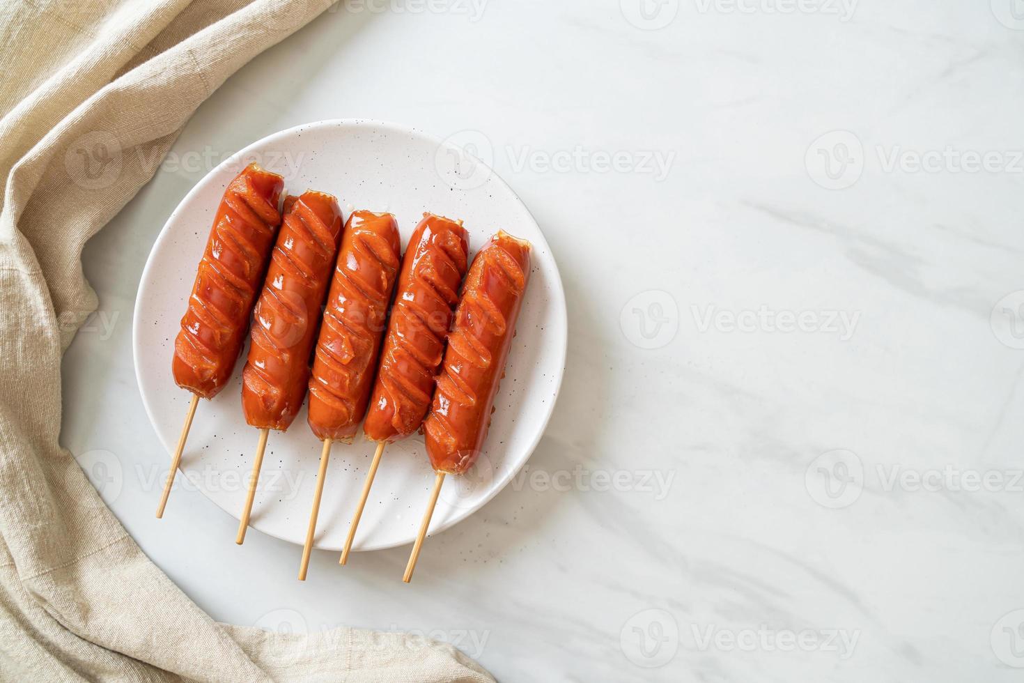 fried sausage skewer on plate photo