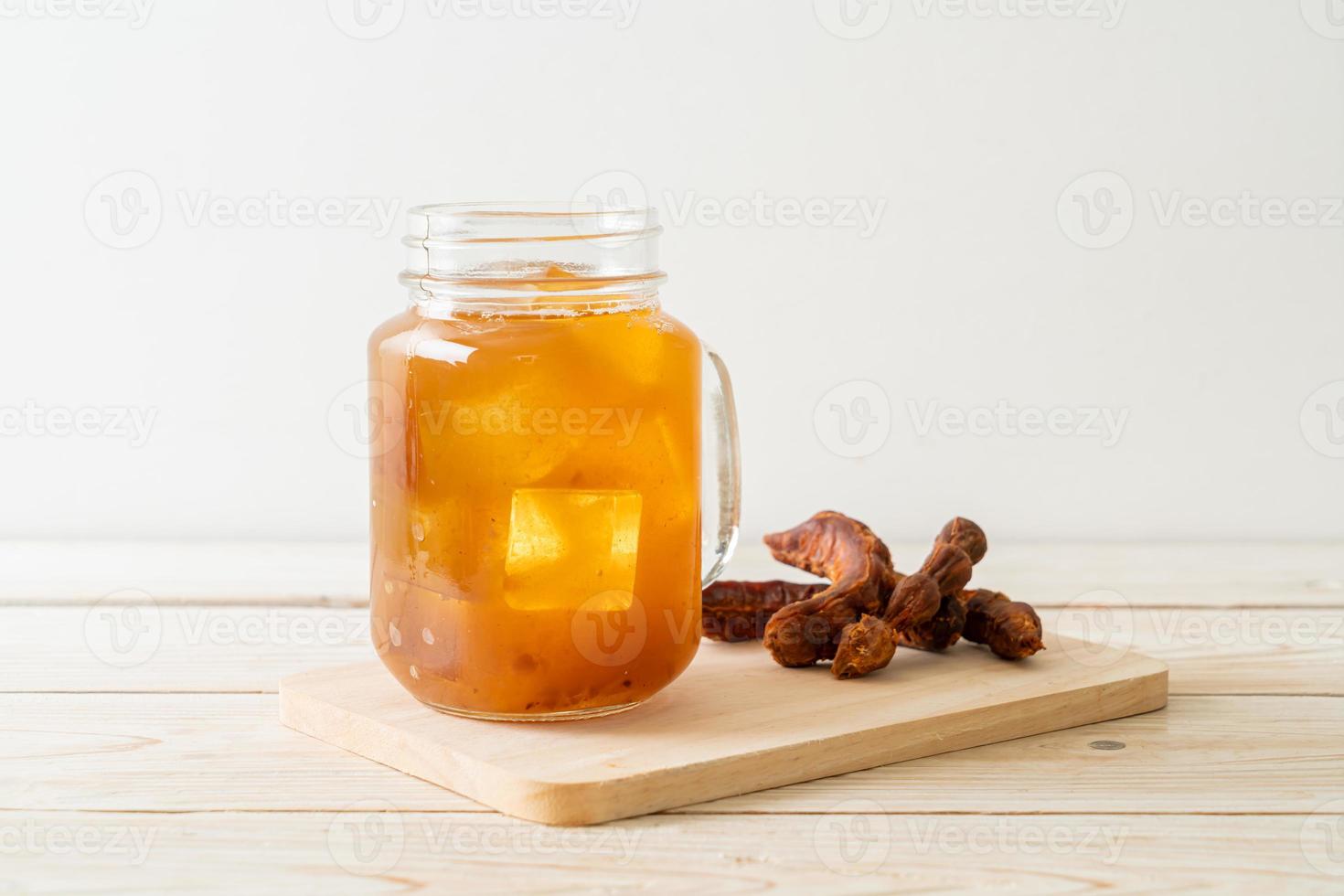 Delicious sweet drink tamarind juice and ice cube photo