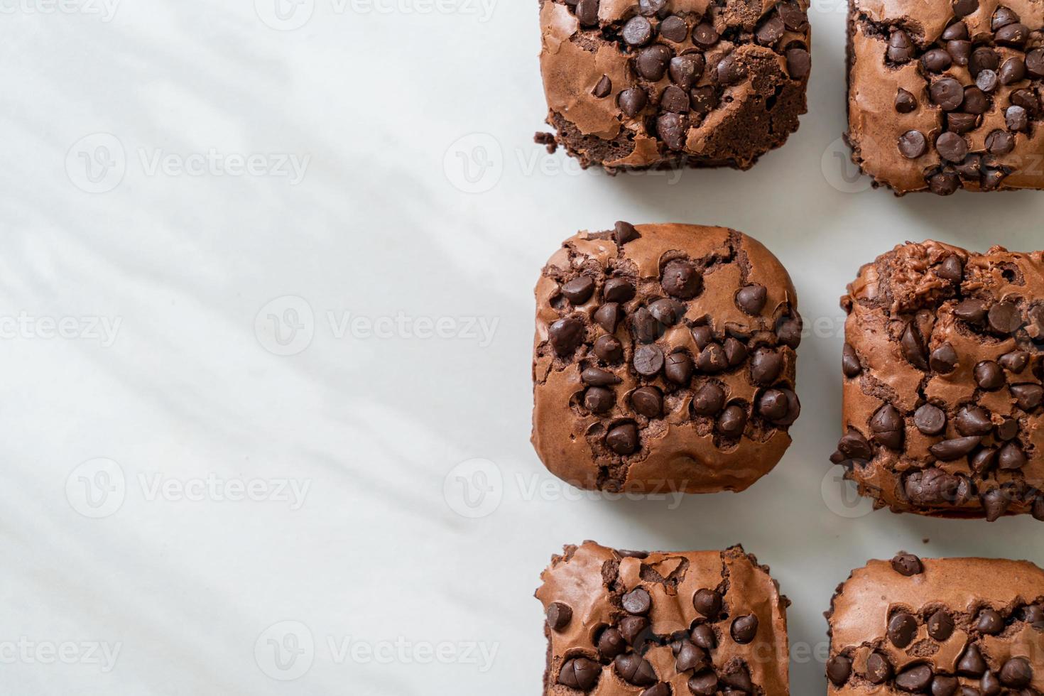 dark chocolate brownies topped by chocolate chips photo