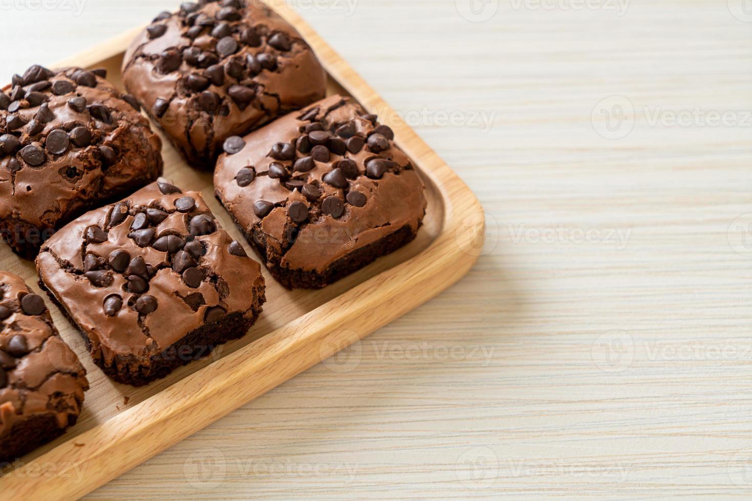 dark chocolate brownies topped by chocolate chips photo