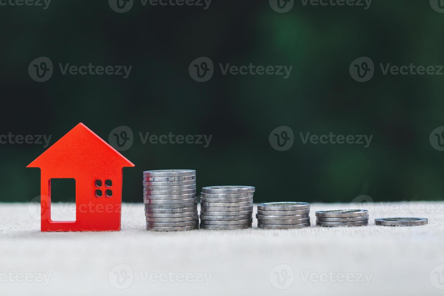 Coin ladder with red model house. photo