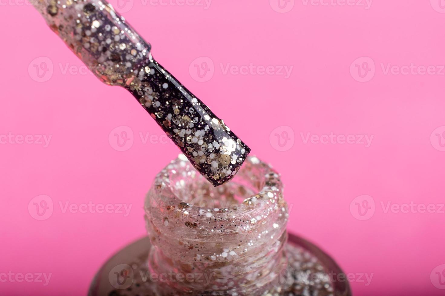 shiny nail polish on pink background, beauty care photo