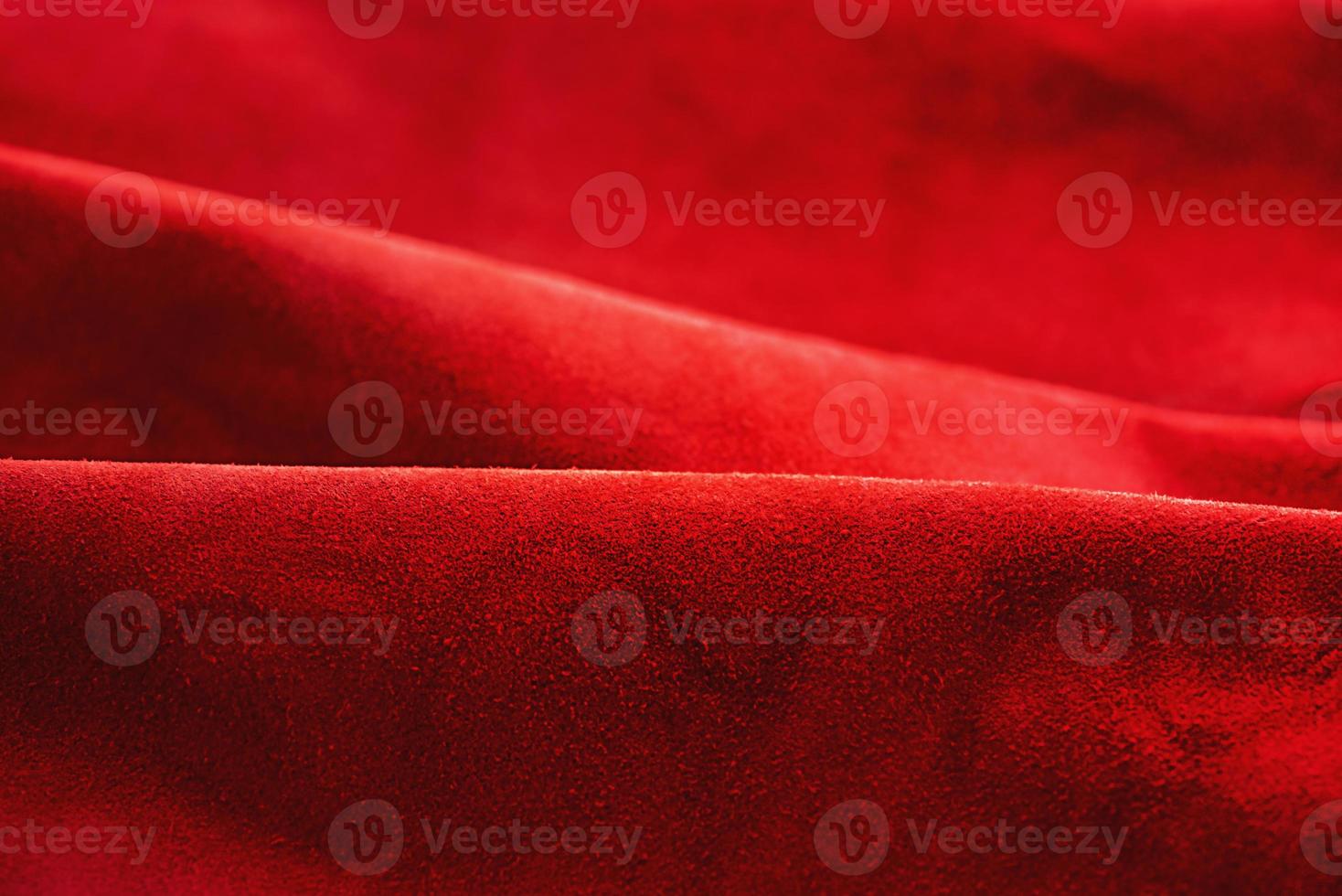 Red suede leather as background. Velvet red texture. photo