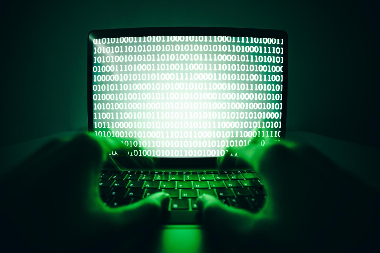 Hacker use laptop to coding virus or malware for hacking server photo