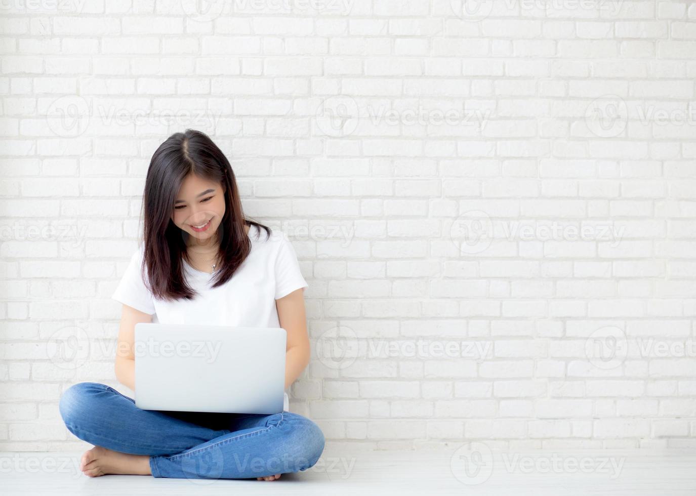 Young asian woman working on laptop computer. photo