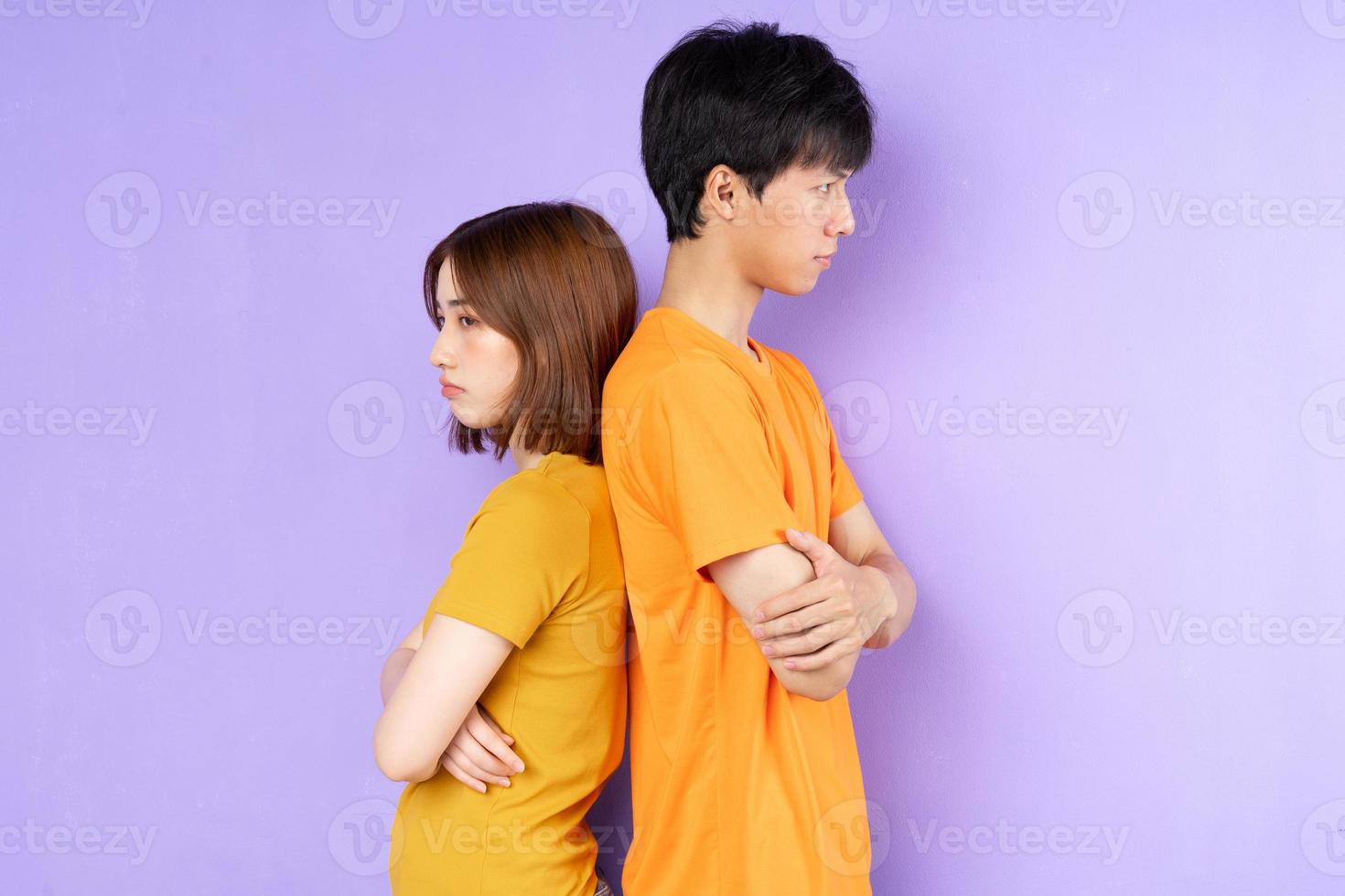 Asian couple portrait, isolated on purple background photo