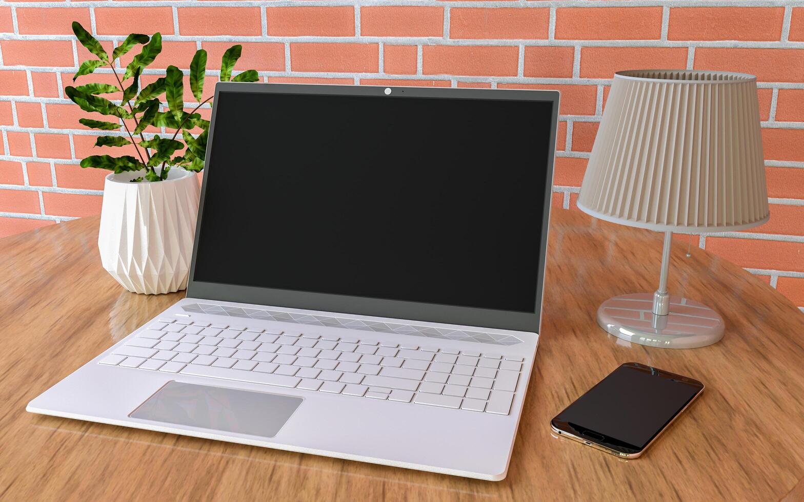 3D laptop, plant, mobile phone and lamp on the table photo