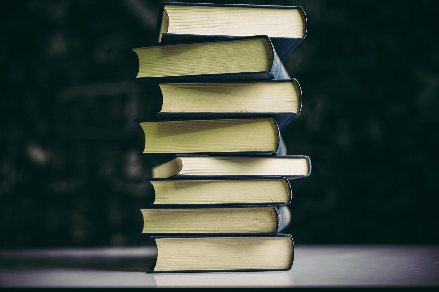 The books are placed in a stack of books on the table photo