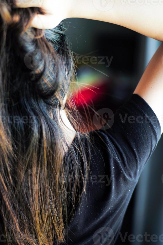 Rear view of woman having the dandruff on the shoulder photo