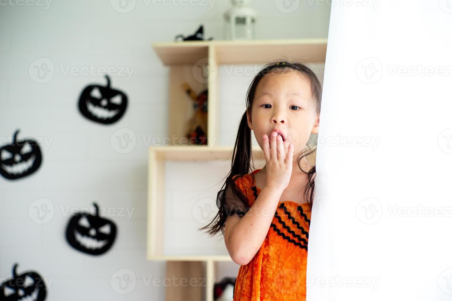 Closeup portrait little girl with surprised face in halloween costume photo