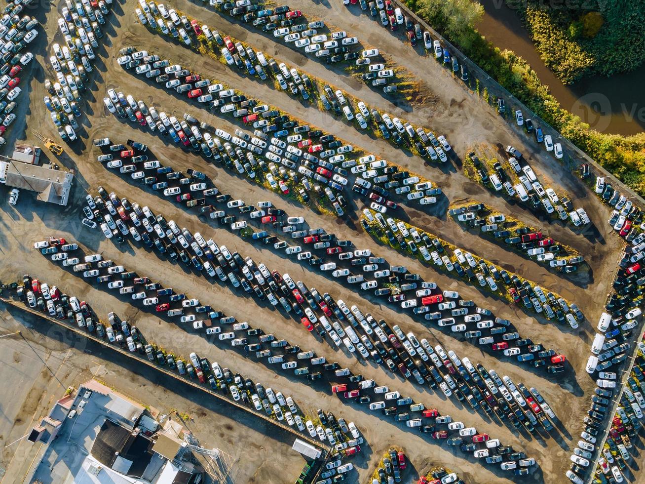 Aerial top view of used car auction for sale in a parking lot photo