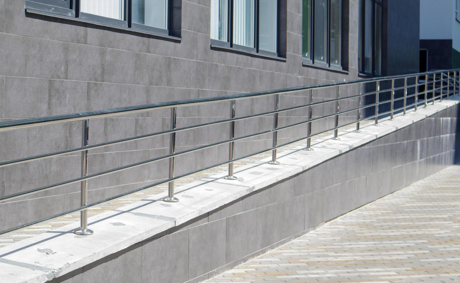 A ramp with stainless steel handrails for wheelchairs, bicycles photo