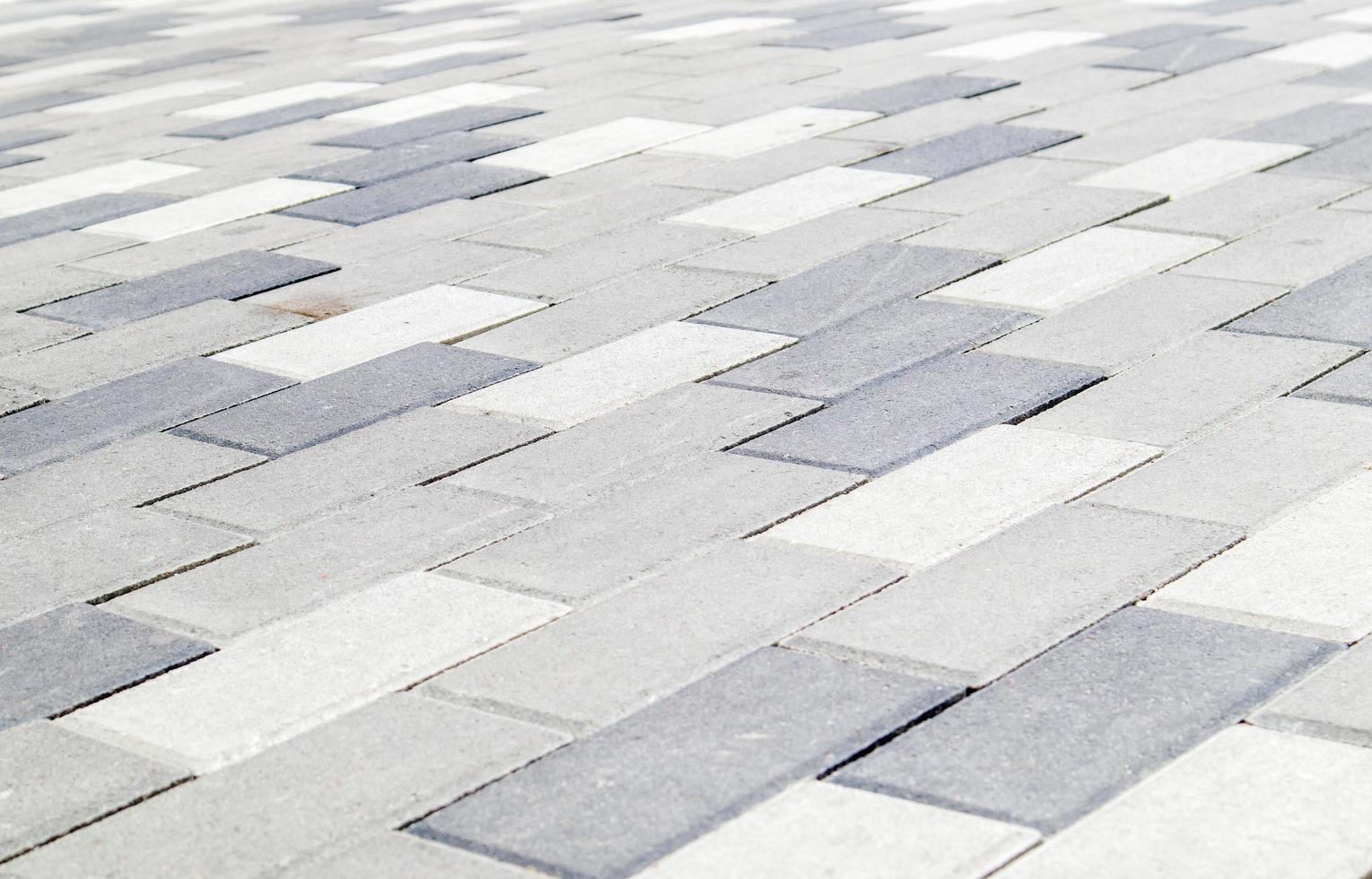 Concrete or paved newly laid gray paving slabs or stones for floors photo