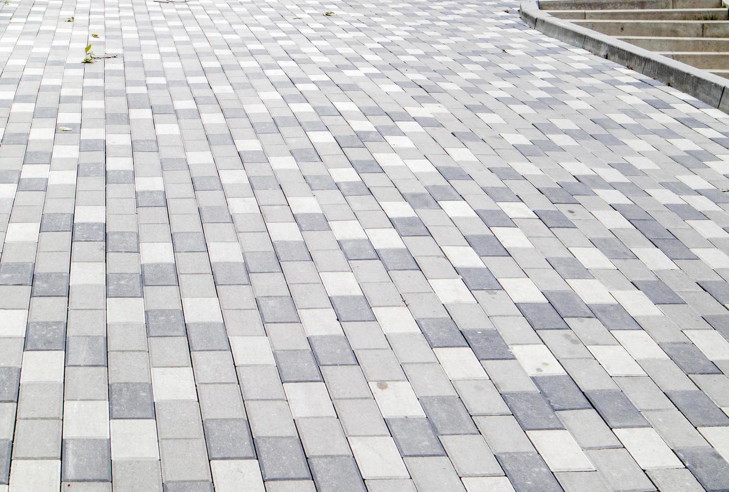 A long descent covered with gray paving slabs. photo