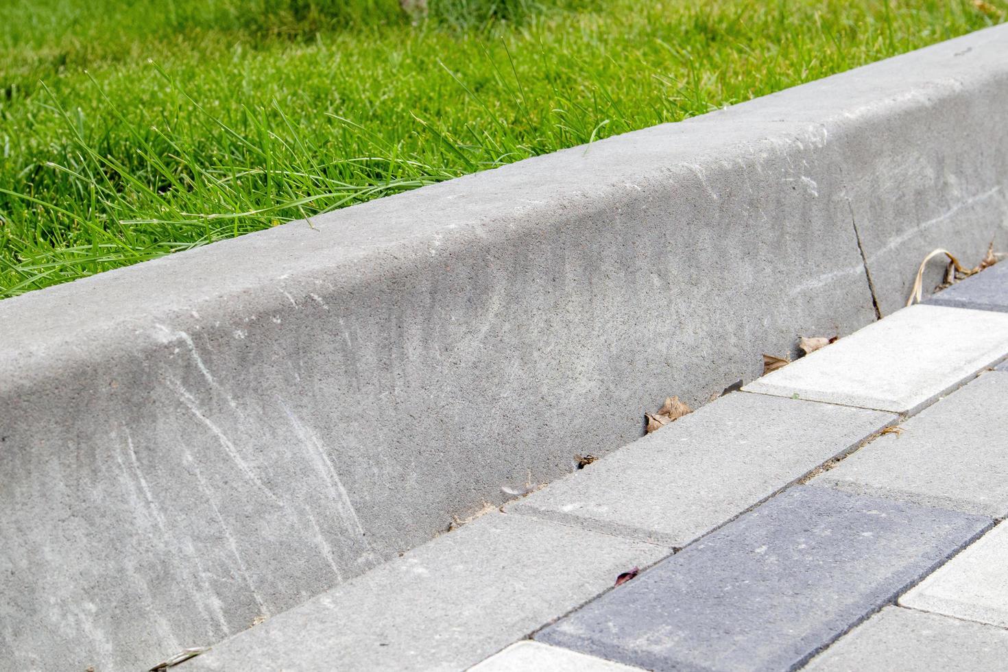 Installation of concrete curbs. Road infrastructure repair. photo