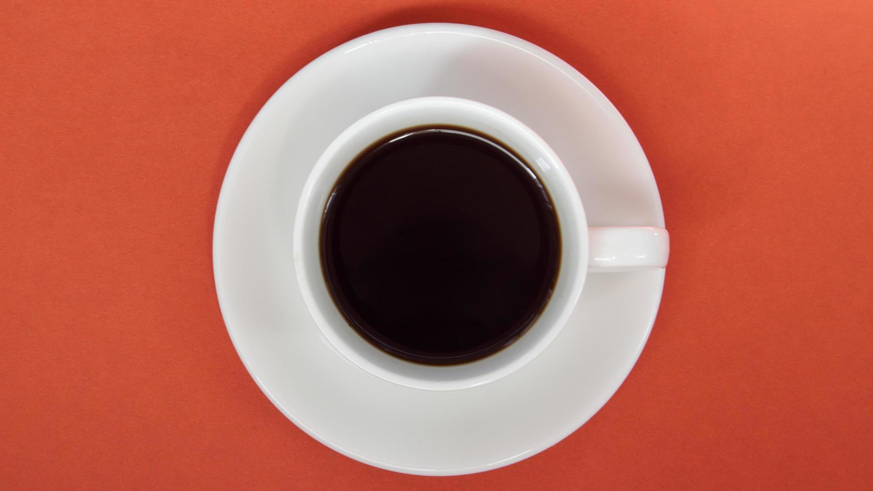 Black coffee in a white coffee cup on a bright background. photo