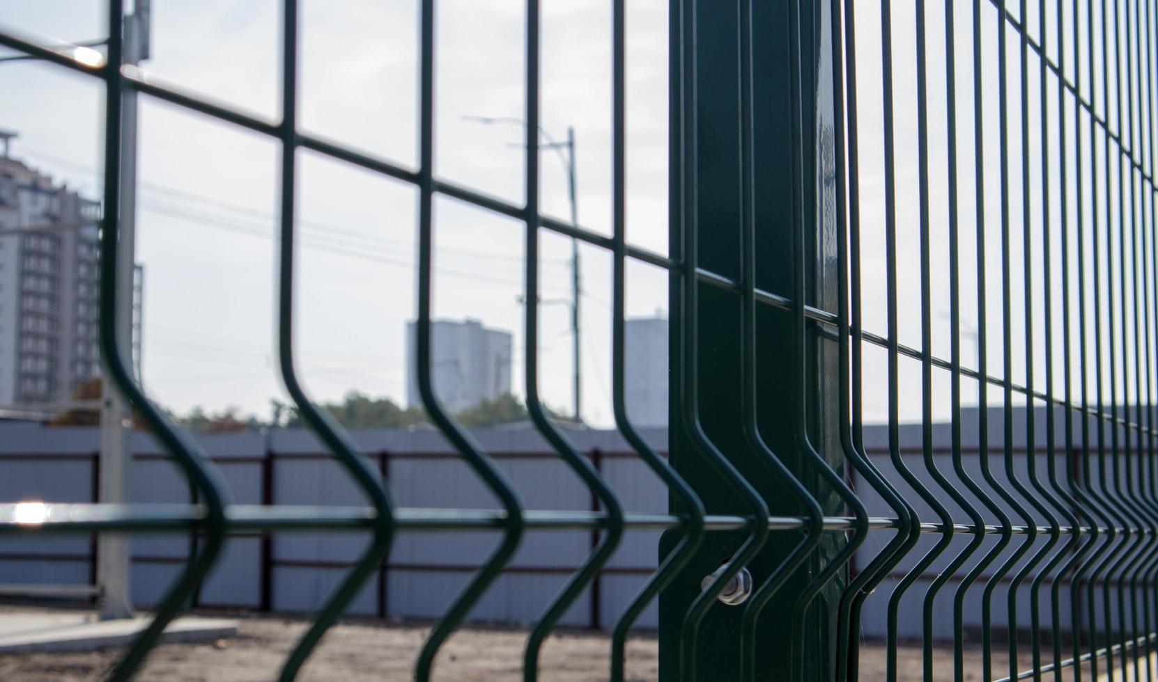 Steel lattice green fence with wire. Fencing. photo