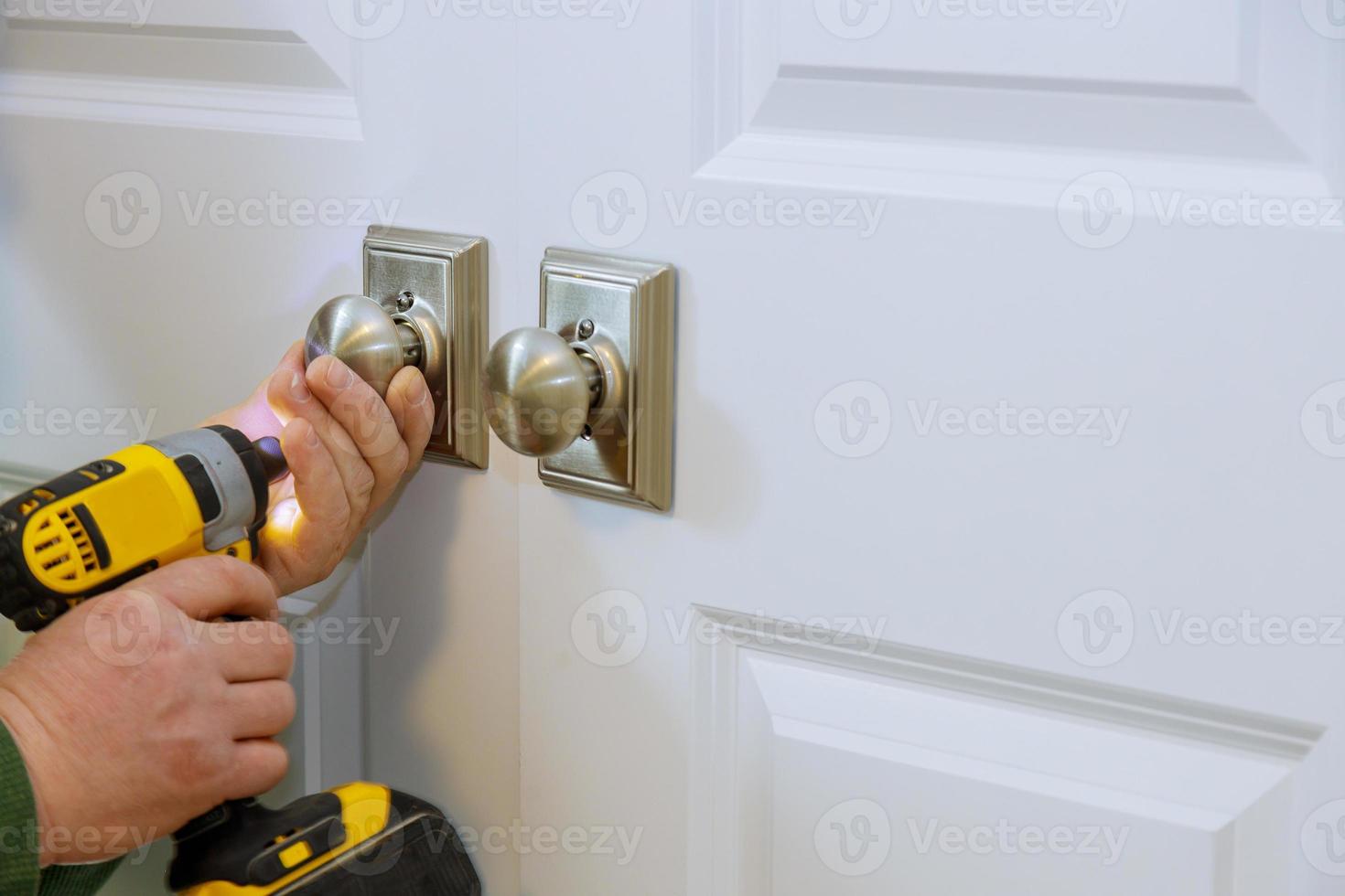 Man installing the dummy lock of the door photo