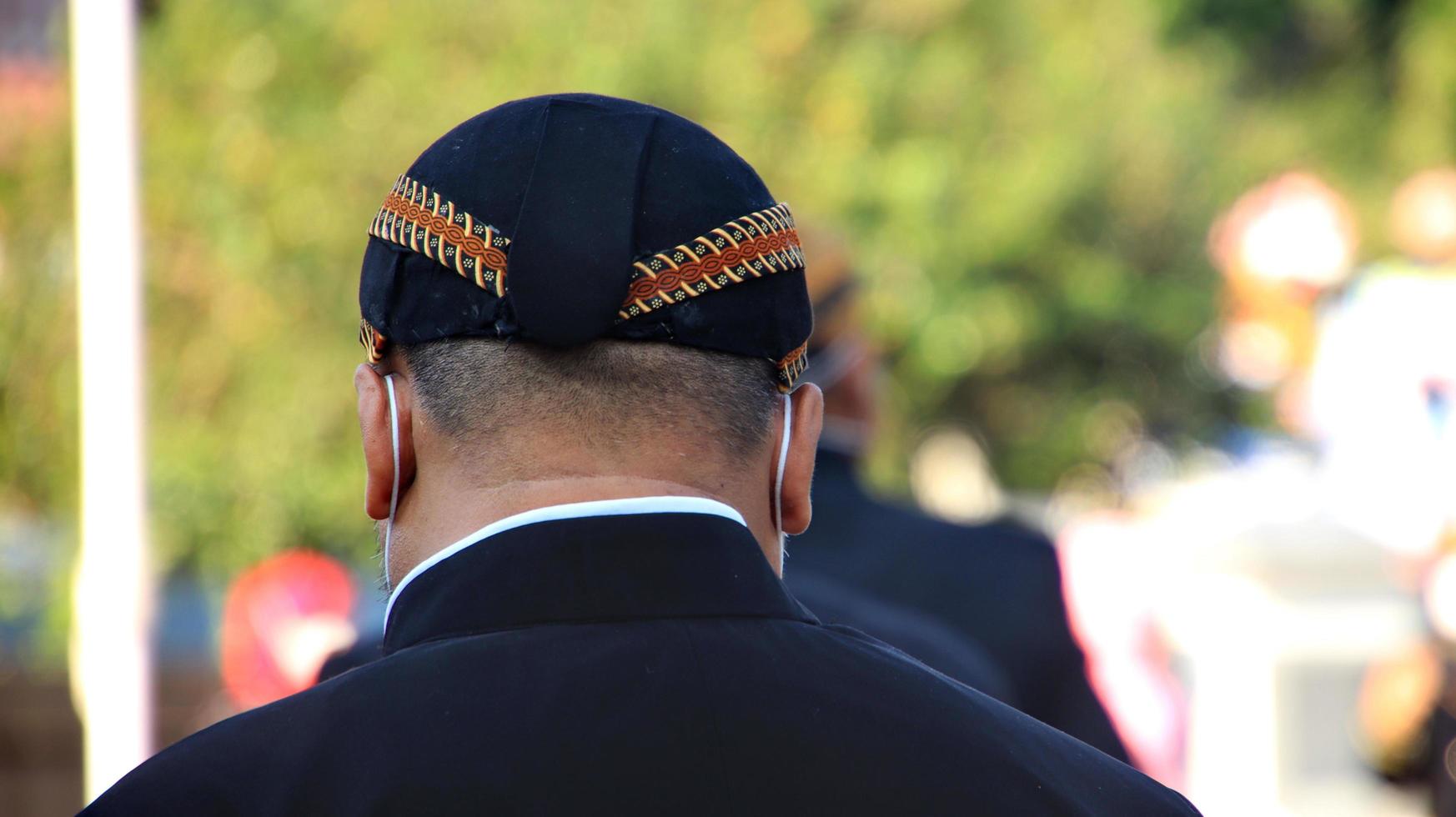 Men wearing traditional Javanese attire with blangkon photo