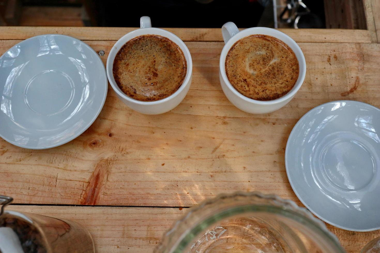 coffee drinks served on wooden tables, with added pine decorations photo