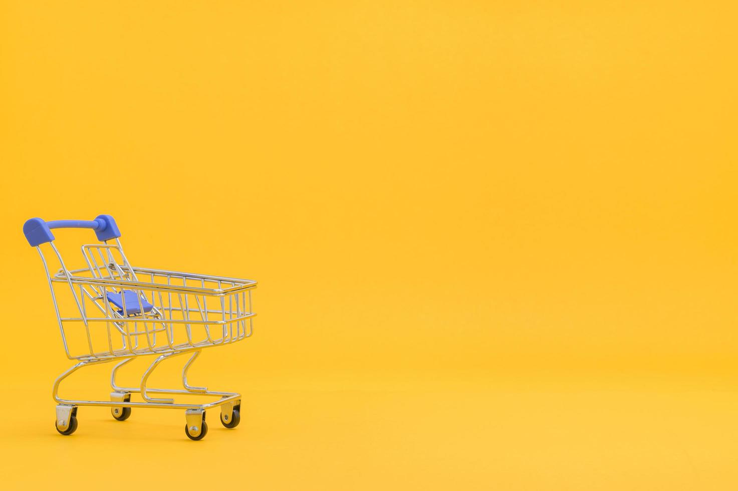 Shopping cart with yellow background photo