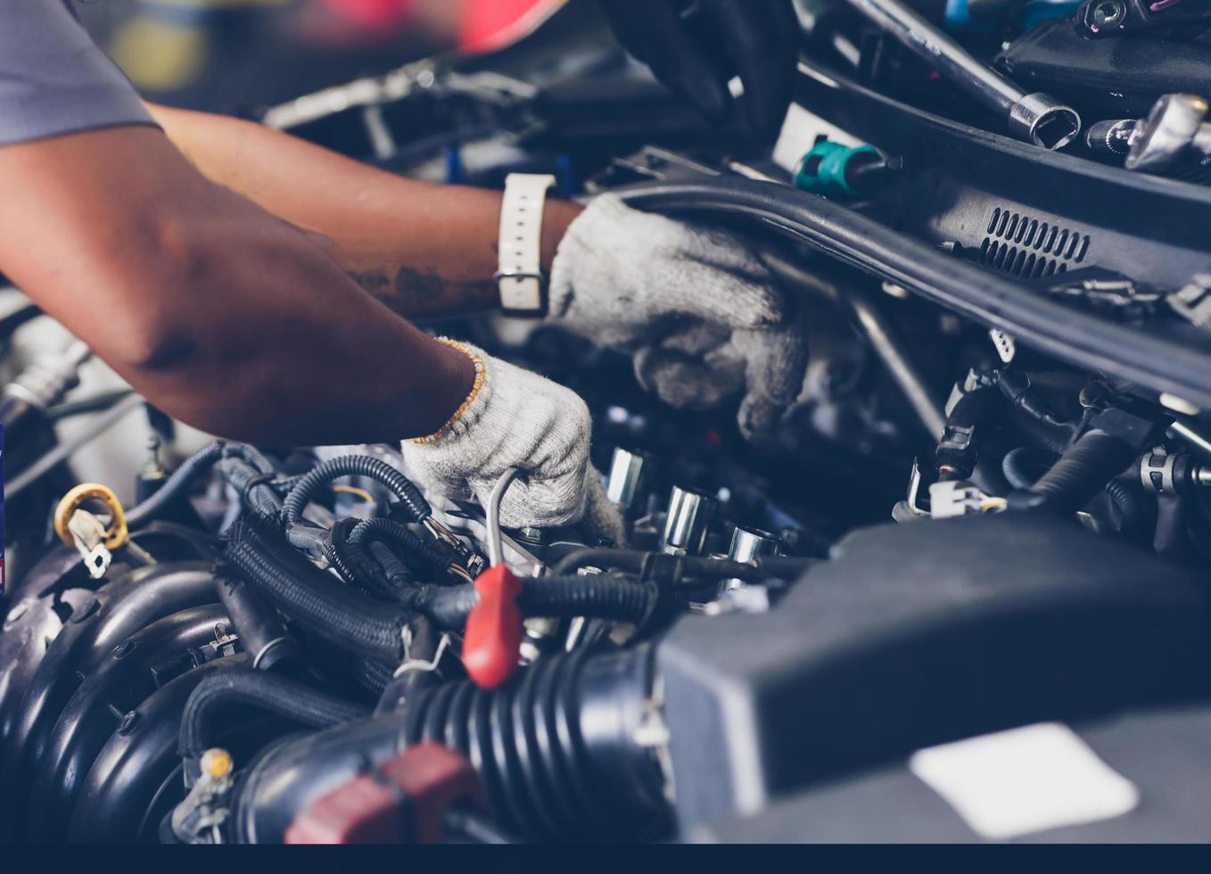 Hands of auto mechanic repairing car. Selective focus. photo