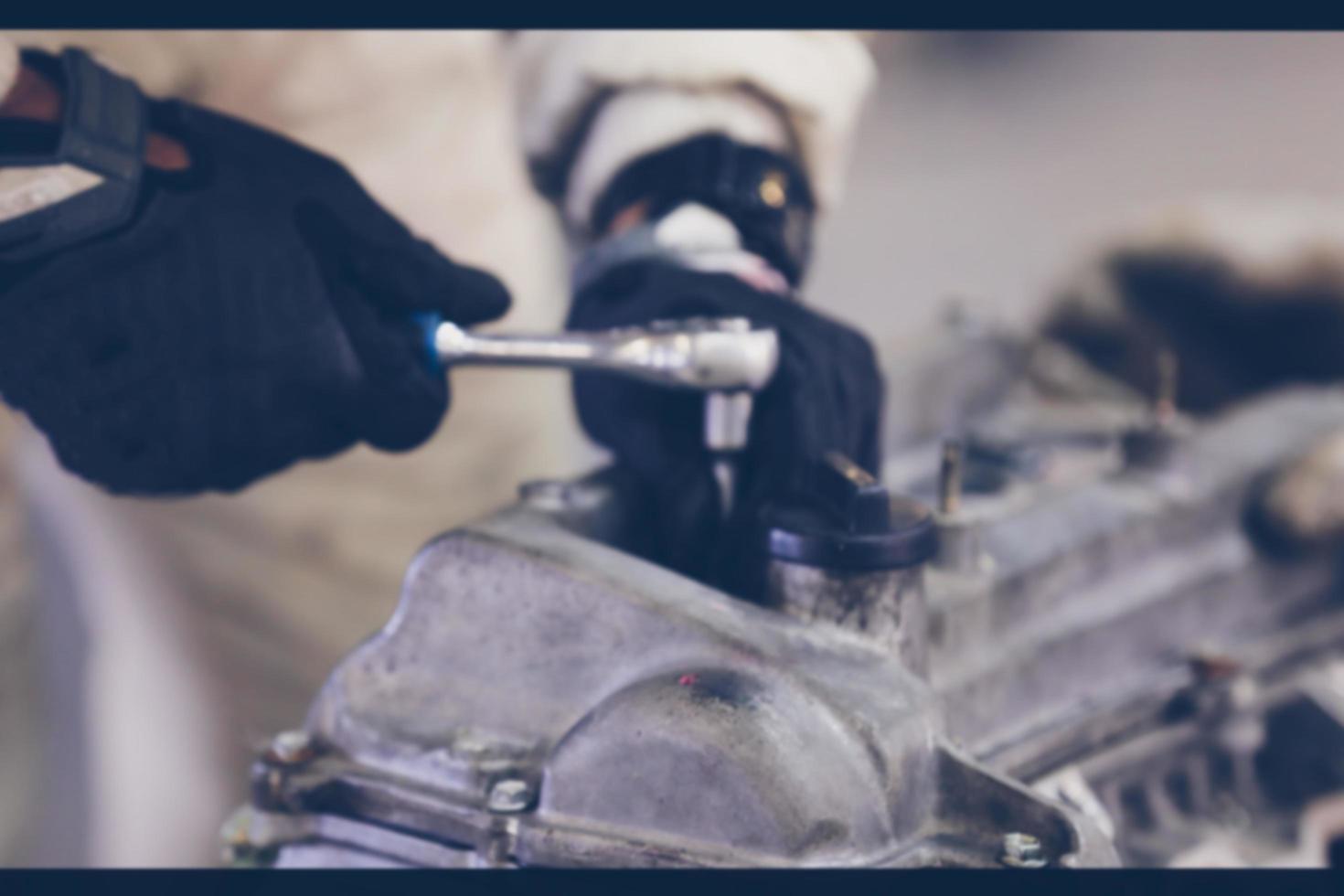 Hands of auto mechanic repairing car. Selective focus. photo