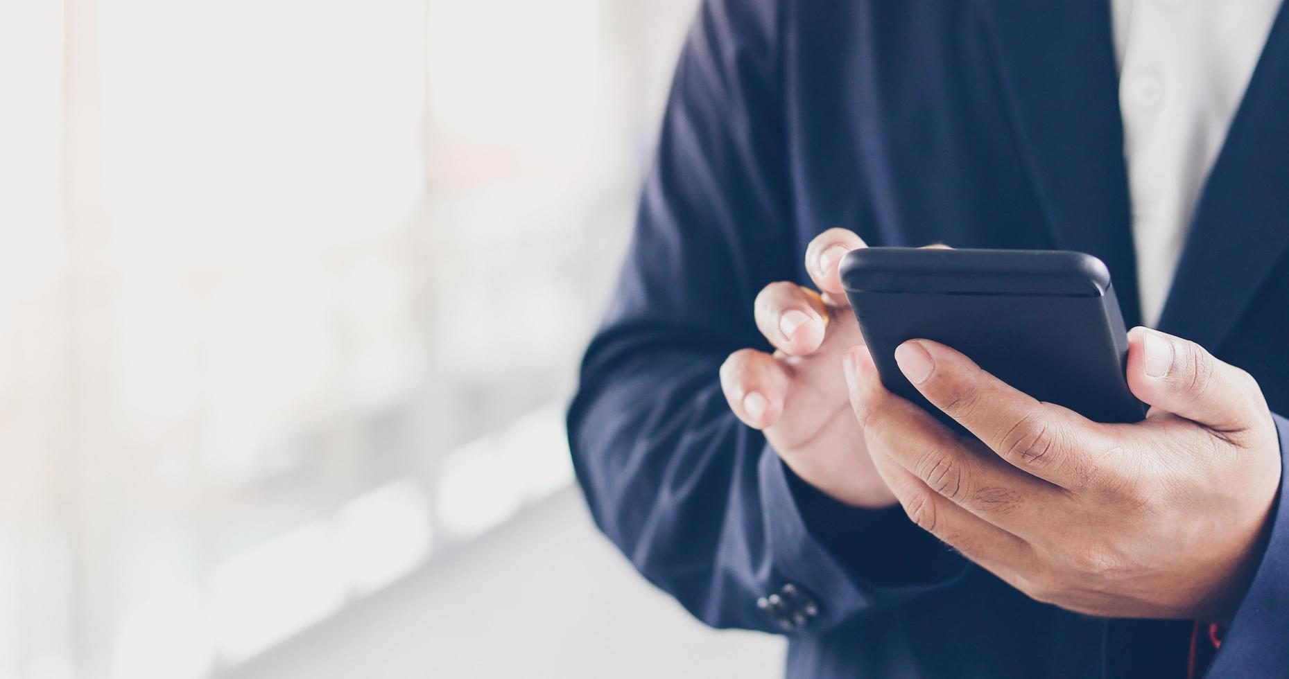 Businessman using phone for texting photo