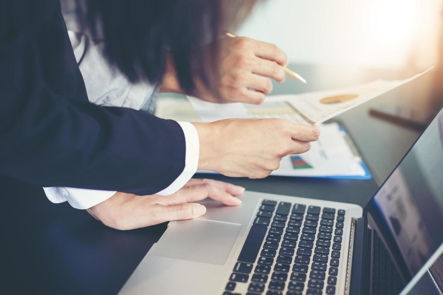 Businesswomen analysing documents photo