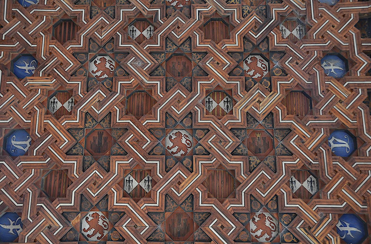 Decorative wooden ceiling with medieval coats of arms and emblems. photo