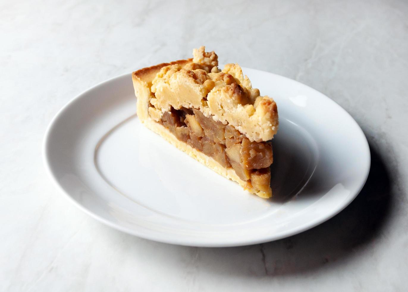 Delicious crumble apple cake on a white plate photo