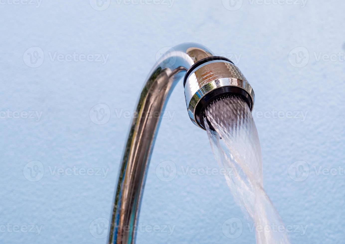 Water flowing from the stainless steel water tap photo