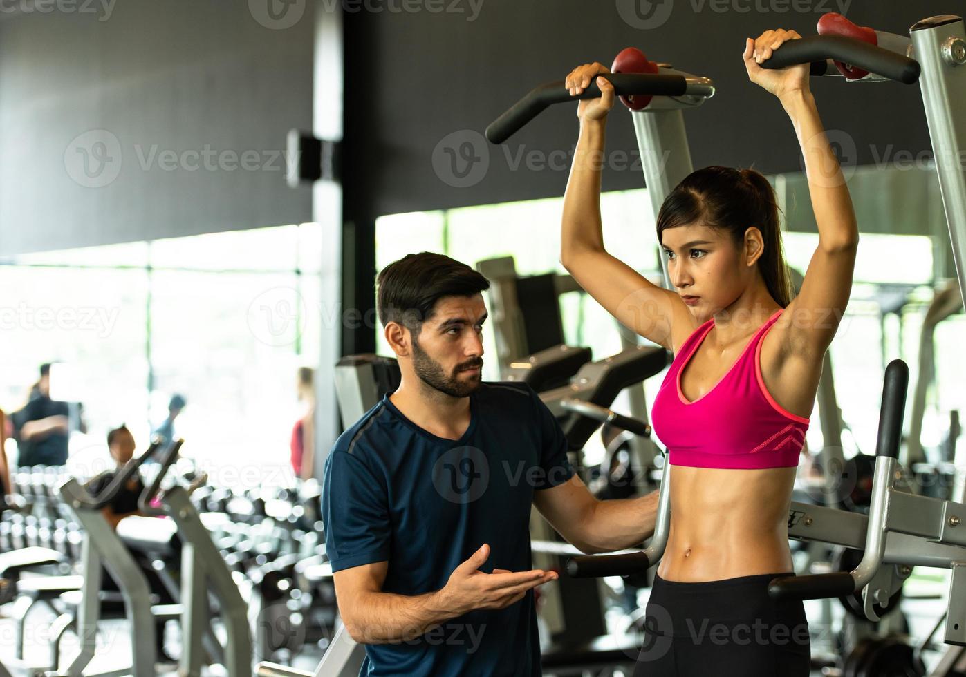 Young couples work out at the gym to strengthen the body. photo