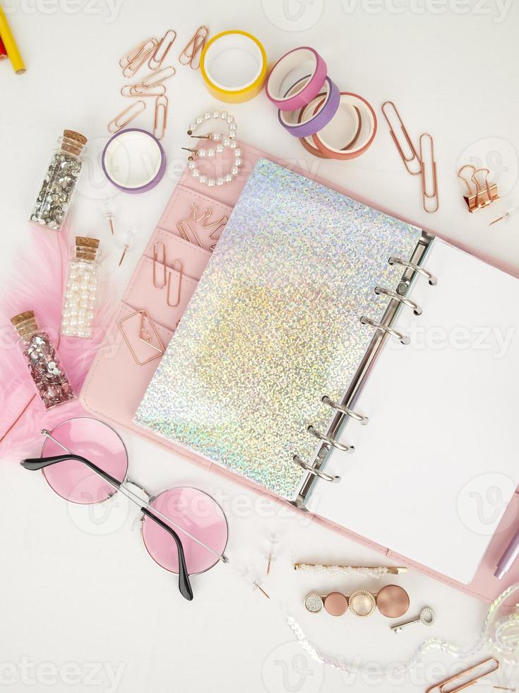 Pink planner with cute stationery photographing in flatlay style photo