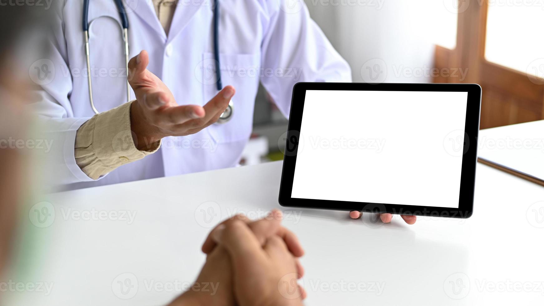 una tableta en la mano del personal médico está consultando a un paciente. foto