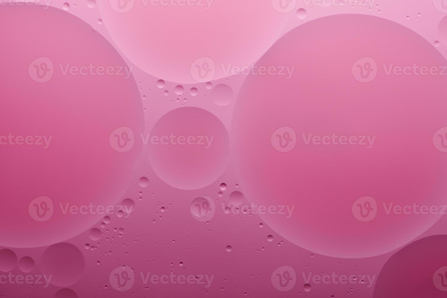 Water and oil, color abstract background based on pink, rose color circles and ovals, macro abstraction, real photo. photo