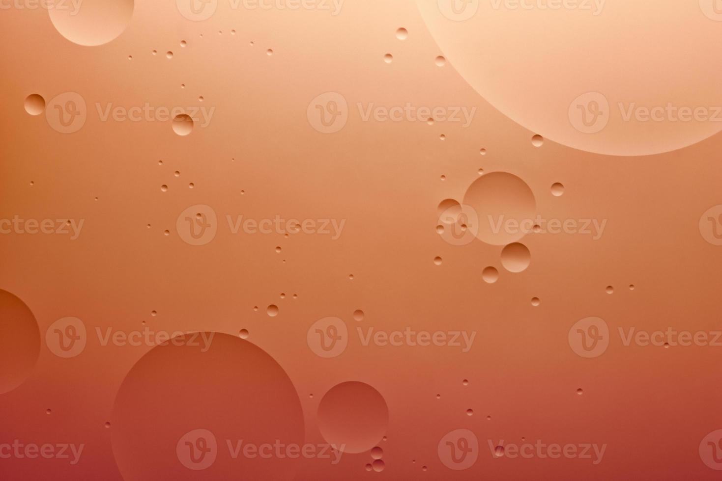 Water and oil, color abstract background based on orange color circles and ovals, macro abstraction, real photo. photo