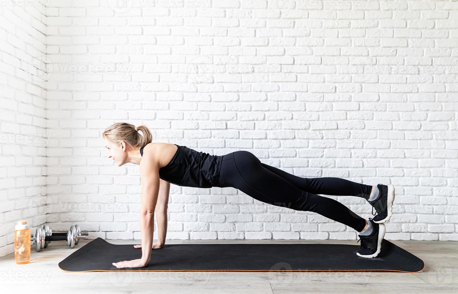 woman doing push ups at home photo