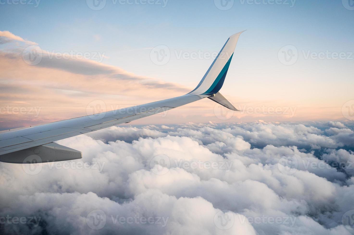 View of wing airplane on cloudy in the sky photo