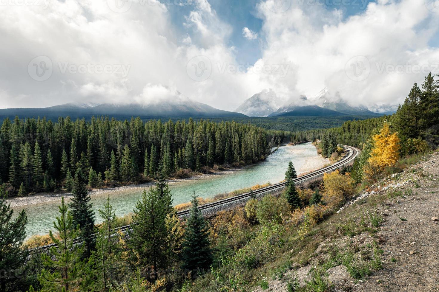 Railway with rocky mountains and cloudy in autumn valley at Morant's Curve photo